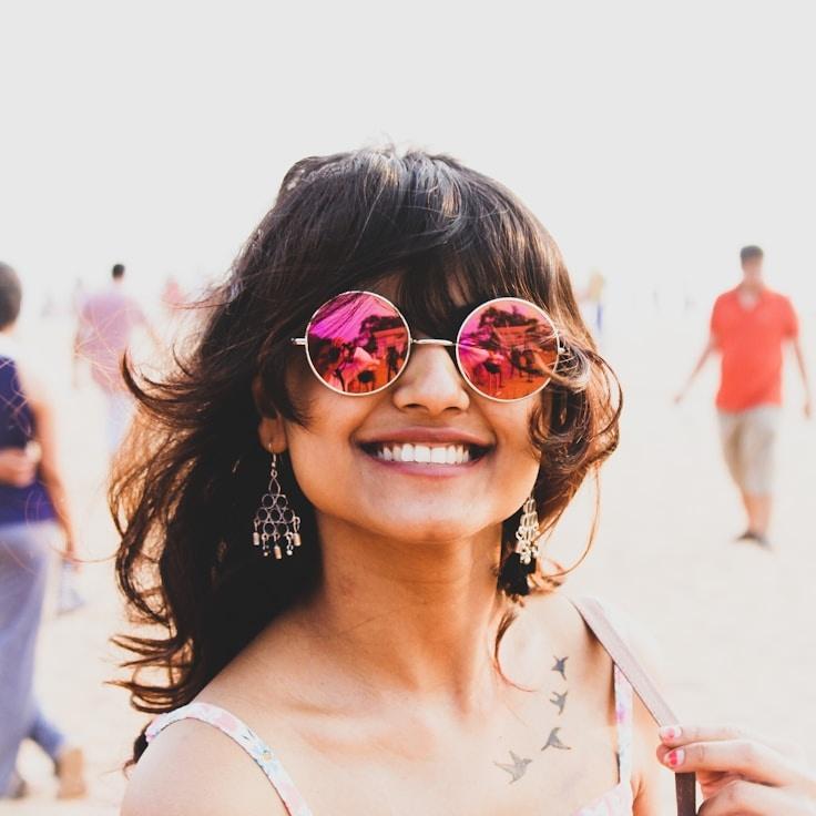 Kaveri Mehta, Lead Design Curator at Maple Orbit Paper, reviewing corporate floral arrangements